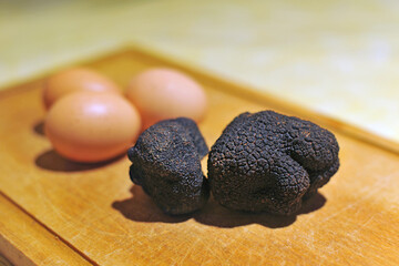 black truffles on a chopping board