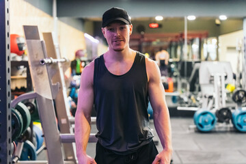 Wide Shot of Red-haired, Muscular Athlete in Gym. Wide shot of red-haired, muscular athlete in gym looking at camera.