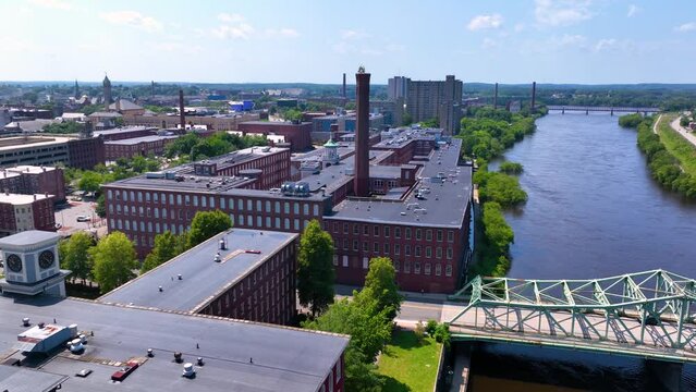 Boott Mills and John E. Cox Memorial Bridge over Merrimack River aerial view in Lowell National Historical Park in historic downtown Lowell, Massachusetts MA, USA. 