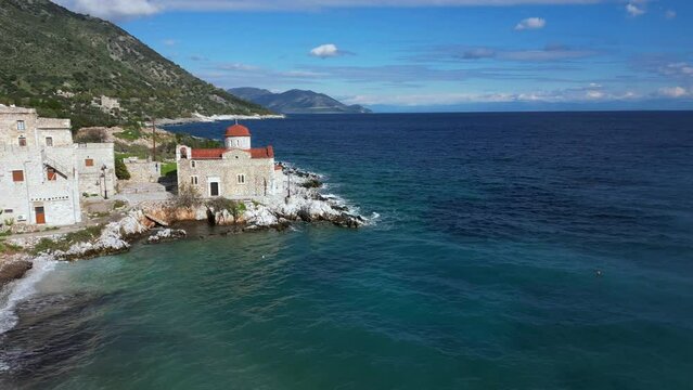 Church by the sea  in the beauty of nature and the sea coast of the Peloponnese, Mani Lakonia - uncontaminated nature and blue sea where you can spend your summer holidays - drone aerial view 