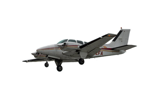 Multi Engine flying aircraft. Isolated general aviation airplane on white background. Retractable landing gear extended, twin engine propeller plane, low wing piston powerplant