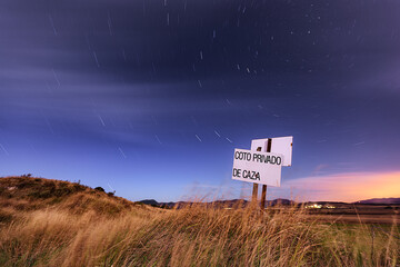 Night view with a starry sky of a field in Castilla, in the province of Burgos with a sign...