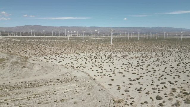 4K Aerials of the windmill farm in Palm Springs, California at the foot of the San Jacinto Mountains, adjacent to Highway 111, which helps provide energy for the Coachella Valley in Riverside County.
