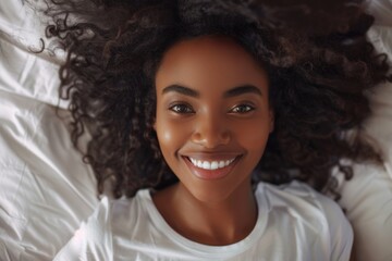 Happy smiling African beauty woman who recently woke up after a healthy and good sleep in bed - obrazy, fototapety, plakaty