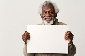smiling old afro man holding a large white blank card with space for text, graphic or text on white background - obrazy, fototapety, plakaty