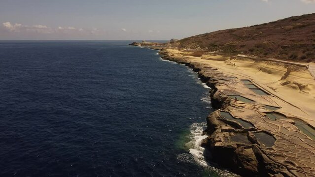 Drone shot of the Salt Pans on the Mediterranean Sea coast in Zebbug village on Gozo, Malta