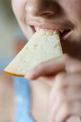 Happy anonymous girl biting fresh cheese slice