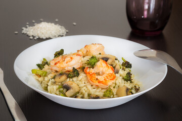 Rice dish with mushrooms, broccoli and shrimp.