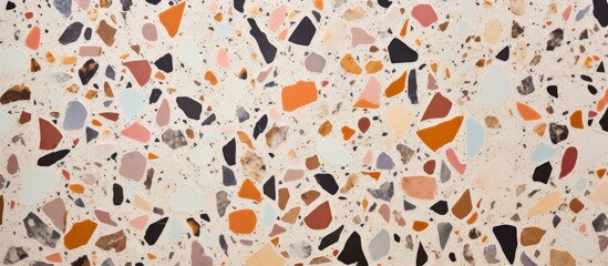 Close up of a vibrant terrazzo floor in peach, magenta, and rock patterns