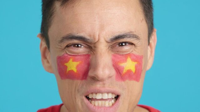 Close up of a man supporting vietnamese team