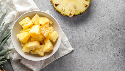 sliced pineapple. top view of sliced pineapple on bowl with copy space