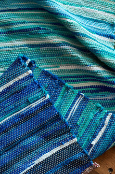 Blue handmade Cotton rag rug, traditional carpet on wooden background
