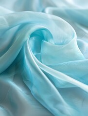 Obraz premium Ethereal folds and curves of pale aqua blue silk fabric create a soft, dreamy composition highlighting the delicate texture.