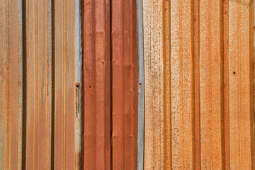Colorful rusted weathered corrugated sheet metal closeup as gunge background