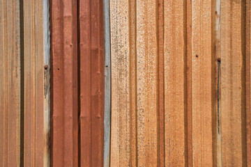 Colorful rusted weathered corrugated sheet metal closeup as gunge background