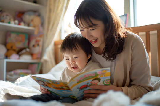 Asian young mother reading a story book to her cute little son at home. Parenting Philosophies