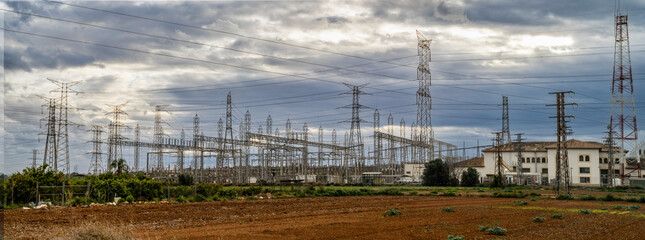 electrical substation and high voltage towers on a cloudy dayu - 772452277