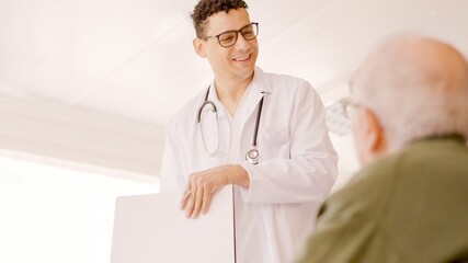 Doctor smiling kindly at an older man