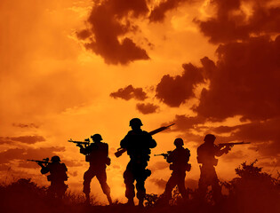 silhouettes of a group of American or Russian border guards, armed soldiers with machine guns and machine guns hold a tactical height against the sunset sky.