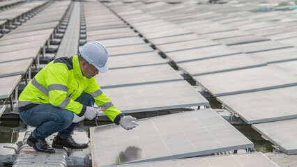 Engineer working at floating solar farm,checking and maintenance with solar batteries near solar panels,supervisor Check the system at the solar power station