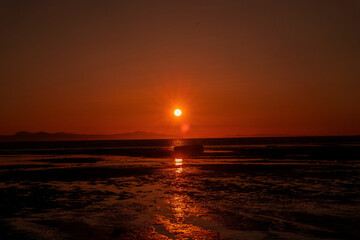 Orange sunset with far horizon, during golden hour.