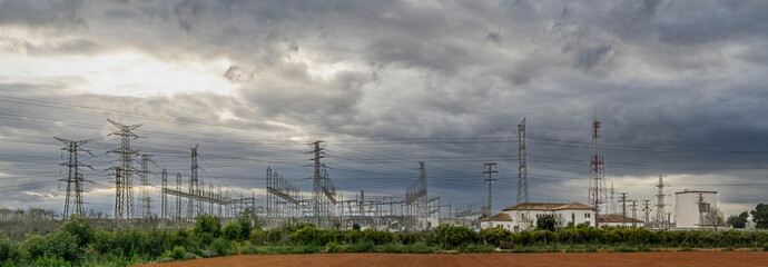electrical substation and high voltage towers on a cloudy dayu - 772463461