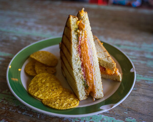 Half cut of a salmon sandwich. Good idea for a nice breakfast or brunch and relaxing life. The salmon is smoked, topped with chopped tomatoes, jalapeno then put into the sandwich. Light, healthy meal