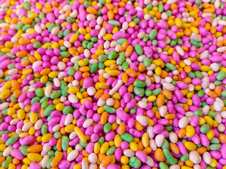 Fototapeta na wymiar Sugar coated colorful Fennel seeds background - Colorful Candy Background 