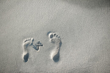 beautiful footprints in the sand near the sea on nature background