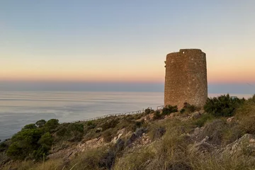 Foto op Plexiglas Cerro Torre Sunset over Mediterranean sea. Historic Torre Vigia De Cerro Gordo, a watchtower looking out for any marauding pirates. La Herradura, Andulasia, Southern Spain