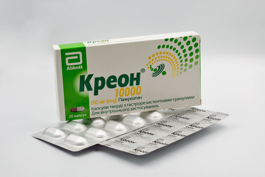 Creon pancreatin pack and blister closeup against white.