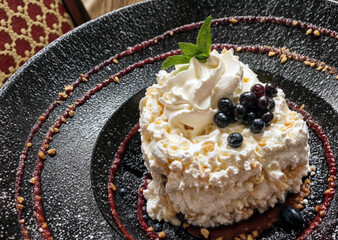 Dessert with blueberries on elegant plate. Delicious treat.