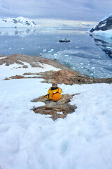 Naklejka premium Tourists visiting Antarctica among snow and penguins