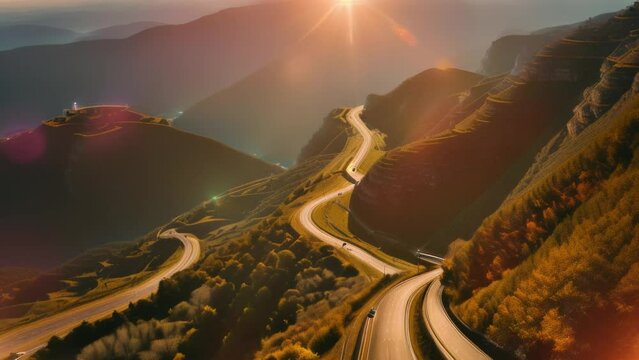 Aerial view of a sunsetlit winding mountain road in the highlands