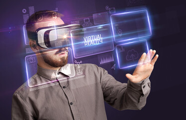 Businessman looking through Virtual Reality glasses, tech concept