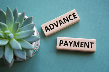 Advance Payment symbol. Concept words Advance Payment on wooden blocks. Beautiful grey green...