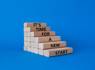 Time for a new start symbol. Wooden blocks with words Time for a new start. Beautiful blue...