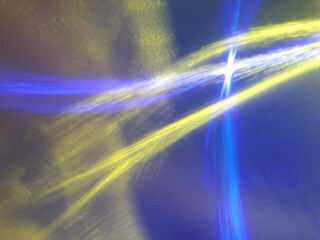 bright light streaks in sky with a cross effect - yellow, blue, white, purple
