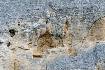 Close-up of an old weathered stone relief depicting a mounted warrior on a horse, Madara, Bulgaria