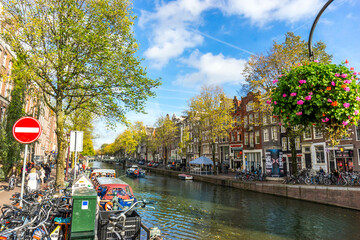 Channel in Amsterdam Netherlands houses river Amstel landmark old European city autumn landscape. - obrazy, fototapety, plakaty