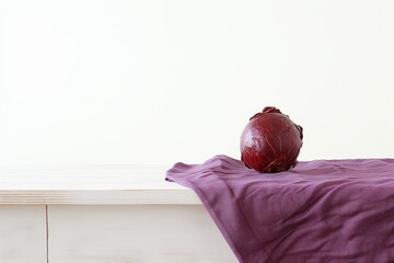 Fresh red cabbage on bedside table against white wall. Organic vegetable with space for text.