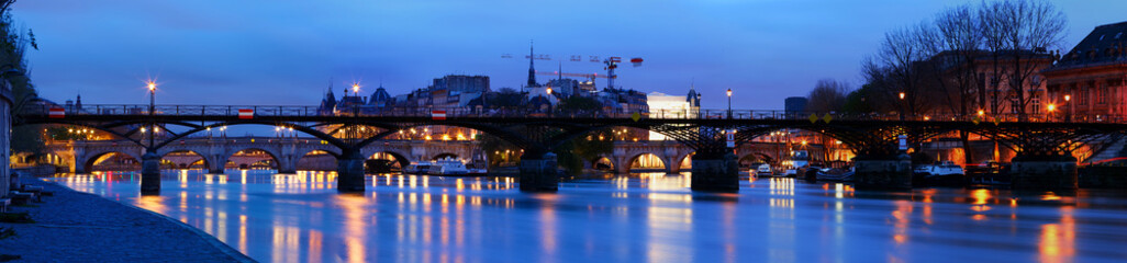 The panoramic view of Paris, Seine river, Arts bridge in the early morning .