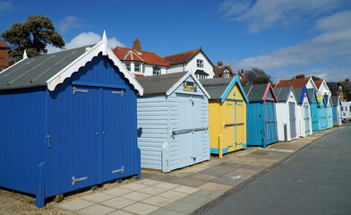 Fototapeta na wymiar Beach Huts on Felixstowe Promenade in sunshine.