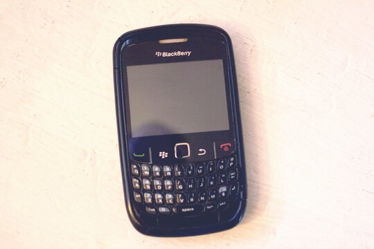 Florence, Italy , April 1st 2024. Vintage Blackberry smartphone telephone with focus on the first row of buttons - tilt-shift lens