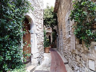 view of the narrow streets and stone houses of eze village in the french riviera