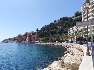 French Riviera. Villefranche-Sur-Mer beach, South of France, summer day with people and clear blue sky