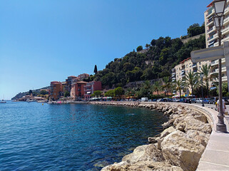 French Riviera. Villefranche-Sur-Mer beach, South of France, summer day with people and clear blue sky
