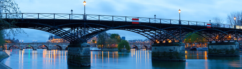 The panoramic view of Paris, Seine river, Arts bridge in the early morning .