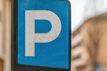 blue and white sign with the letter p on it