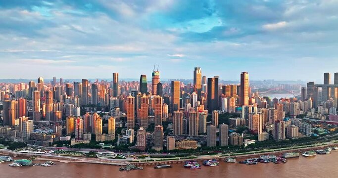 Aerial panning shot of Chongqing city center buildings skyline and river natural landscape at sunset